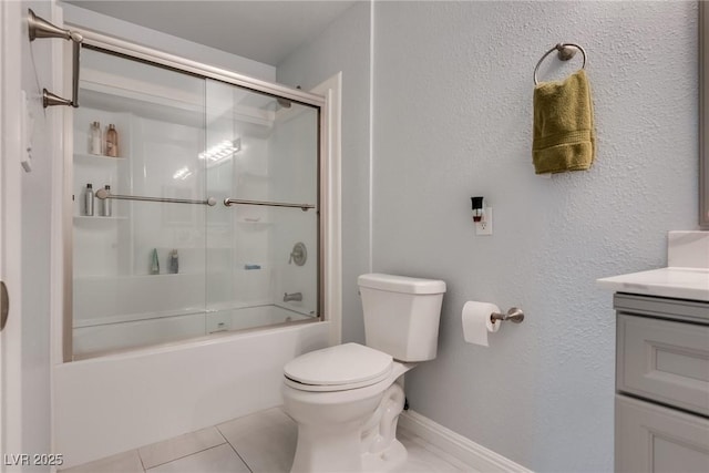 full bathroom featuring enclosed tub / shower combo, vanity, toilet, and tile patterned flooring