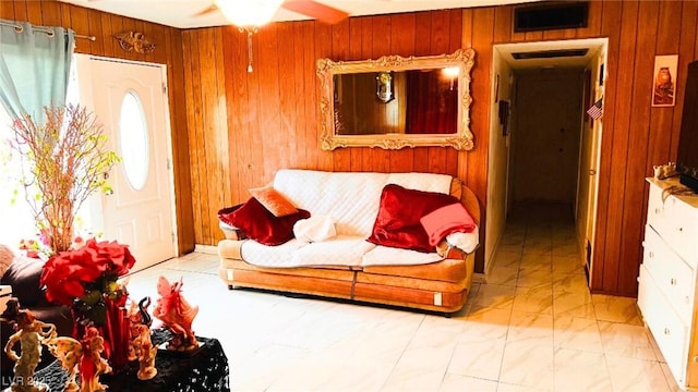 4130 Balboa Ave, Las Vegas, NV 89121 - living room featuring wood walls, a ceiling fan, and light marble finish flooring
