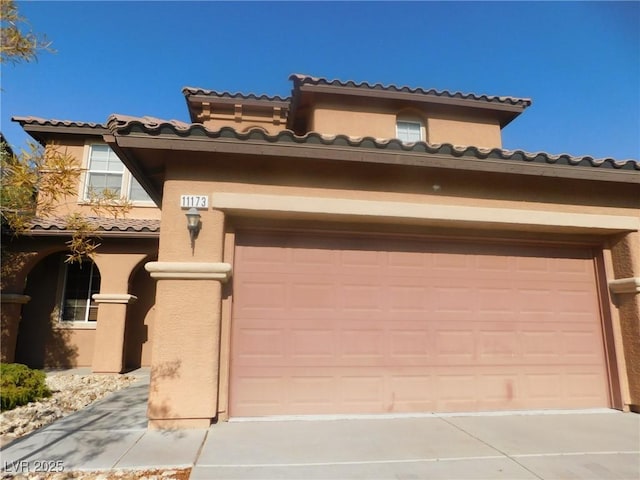 mediterranean / spanish-style home featuring a garage