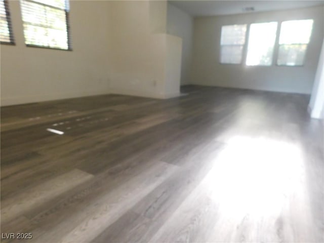 spare room with dark hardwood / wood-style flooring