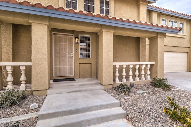 doorway to property with a garage