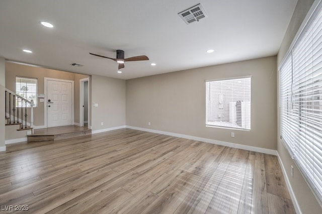 spare room featuring ceiling fan and light wood-type flooring