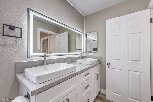 bathroom with vanity and hardwood / wood-style floors