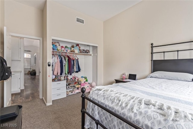 bedroom with a towering ceiling, carpet floors, and a closet