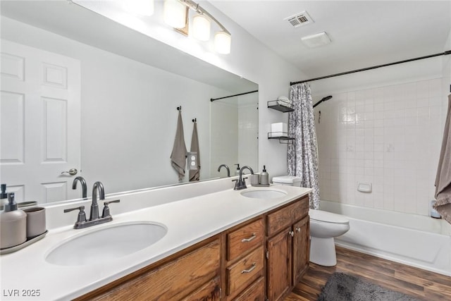 full bathroom with vanity, wood-type flooring, toilet, and shower / bath combo