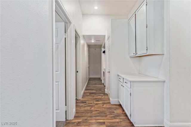 hall with dark wood-type flooring