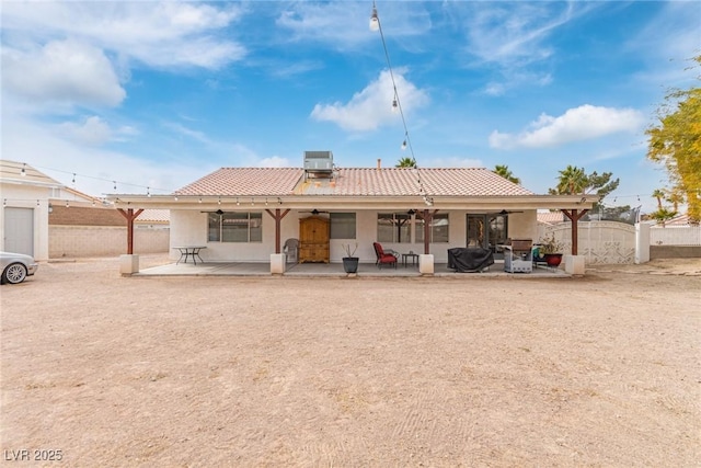 back of house with central AC unit, a patio, and ceiling fan