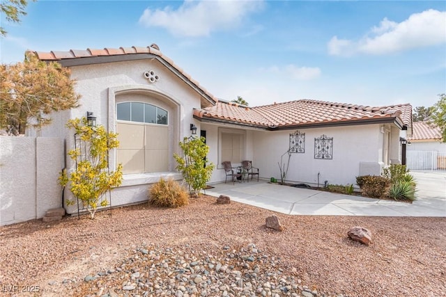 mediterranean / spanish-style house with a patio