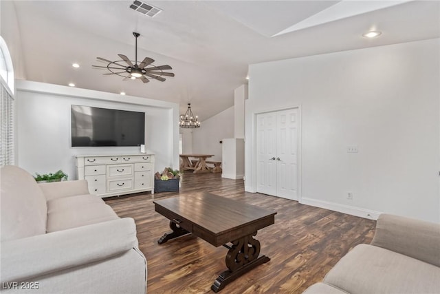 living room featuring vaulted ceiling, ceiling fan with notable chandelier, and dark hardwood / wood-style flooring