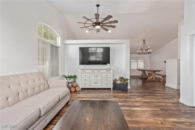 living room featuring lofted ceiling, ceiling fan with notable chandelier, and dark hardwood / wood-style flooring