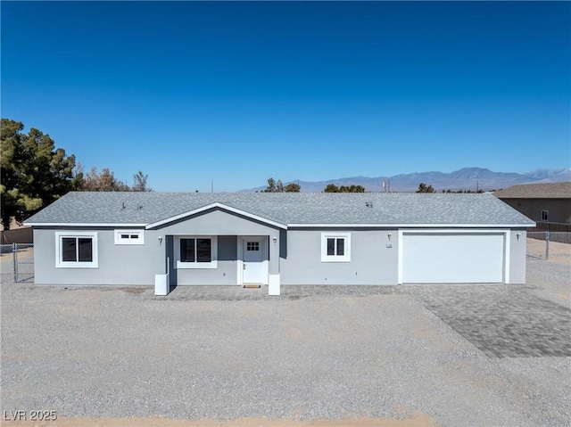 single story home featuring a garage and a mountain view