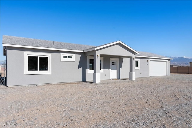 ranch-style house featuring a garage and a mountain view