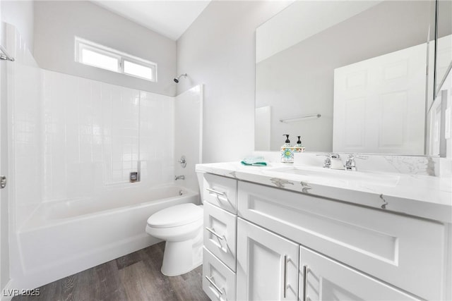 full bathroom featuring vanity, wood-type flooring, shower / washtub combination, and toilet