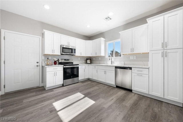 kitchen featuring sink, white cabinets, and appliances with stainless steel finishes