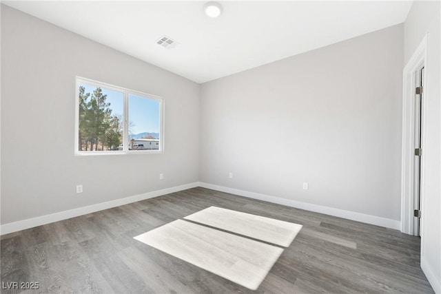 unfurnished room with dark wood-type flooring