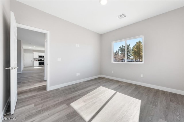 unfurnished room with wood-type flooring