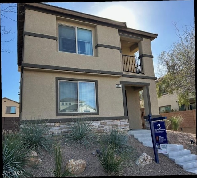 view of front of house featuring a balcony