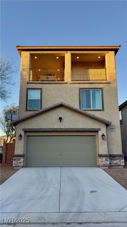 view of front of home with a garage and a balcony