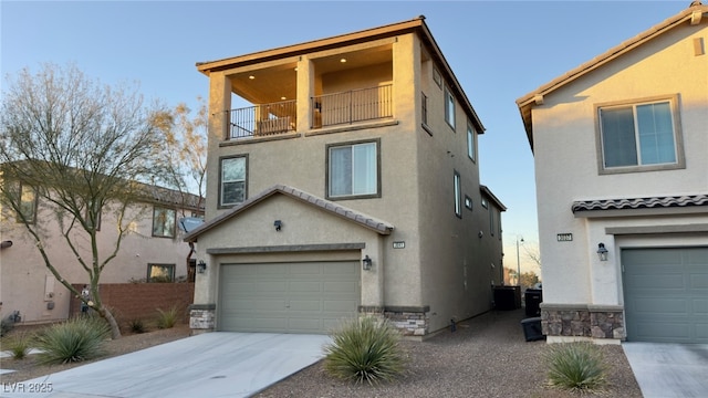 view of front of house featuring a garage, a balcony, and central AC