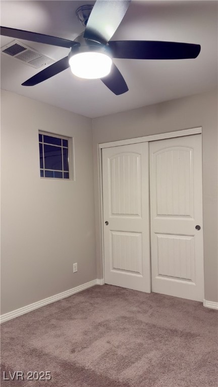 unfurnished bedroom featuring ceiling fan, carpet flooring, and a closet