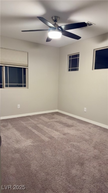 carpeted empty room featuring ceiling fan