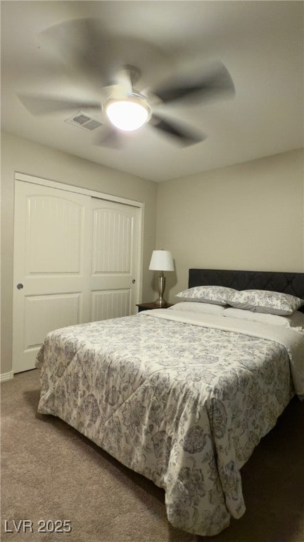 carpeted bedroom with ceiling fan and a closet