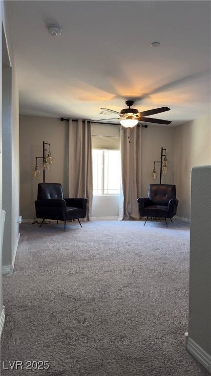 living area with ceiling fan and carpet flooring