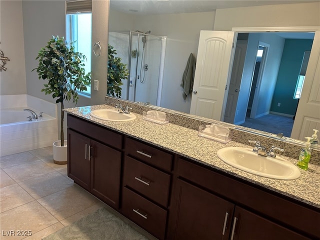 bathroom with tile patterned flooring, vanity, and plus walk in shower