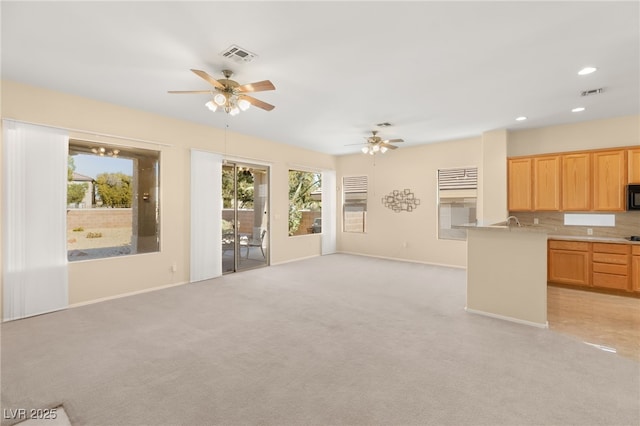 interior space with ceiling fan and light carpet