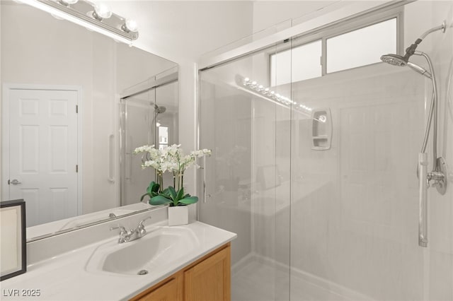 bathroom with an enclosed shower and vanity