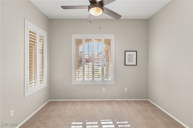 carpeted spare room with ceiling fan