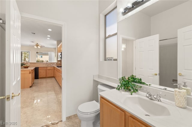 bathroom with vanity, ceiling fan, and toilet