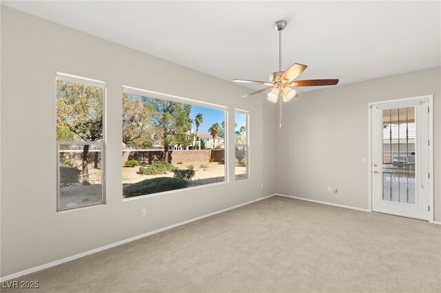 carpeted spare room with ceiling fan