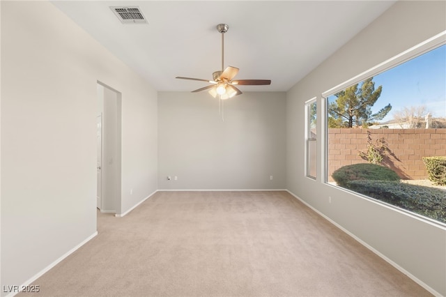 carpeted empty room featuring ceiling fan