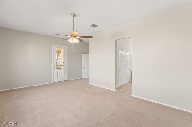 carpeted spare room with ceiling fan