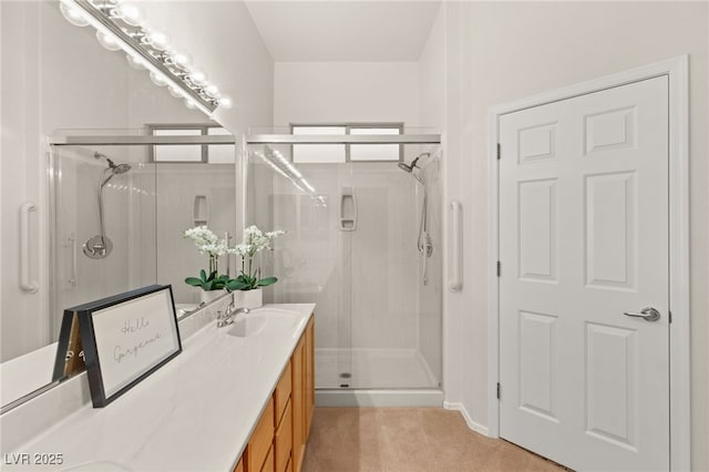 bathroom featuring vanity and a shower with shower door