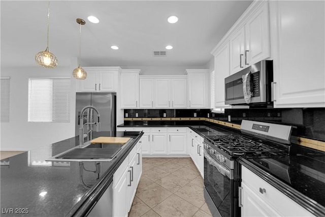 2033 Old Field Ave, North Las Vegas, NV 89081 - kitchen with appliances with stainless steel finishes, a sink, decorative backsplash, white cabinets, and recessed lighting