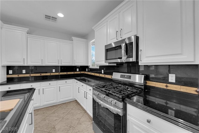2033 Old Field Ave, North Las Vegas, NV 89081 - kitchen with appliances with stainless steel finishes, decorative backsplash, and white cabinetry
