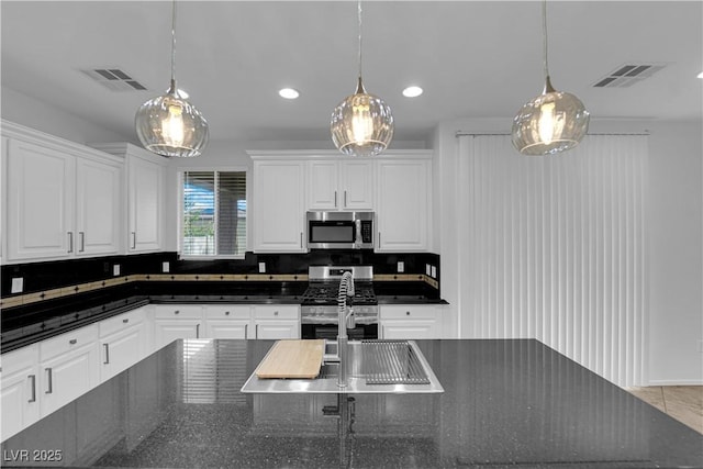 2033 Old Field Ave, North Las Vegas, NV 89081 - kitchen featuring stainless steel appliances, white cabinetry, recessed lighting, hanging light fixtures, and a sink