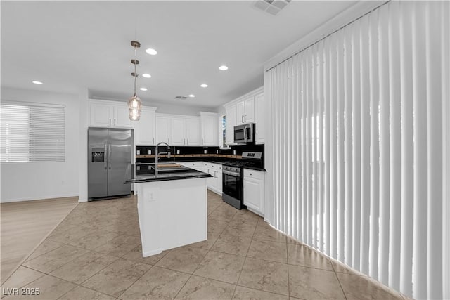 2033 Old Field Ave, North Las Vegas, NV 89081 - kitchen with appliances with stainless steel finishes, dark countertops, recessed lighting, white cabinetry, and decorative light fixtures