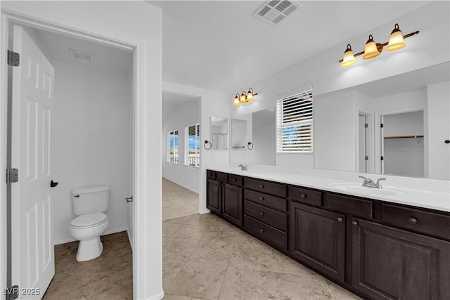 2033 Old Field Ave, North Las Vegas, NV 89081 - full bath with double vanity, toilet, baseboards, and tile patterned floors
