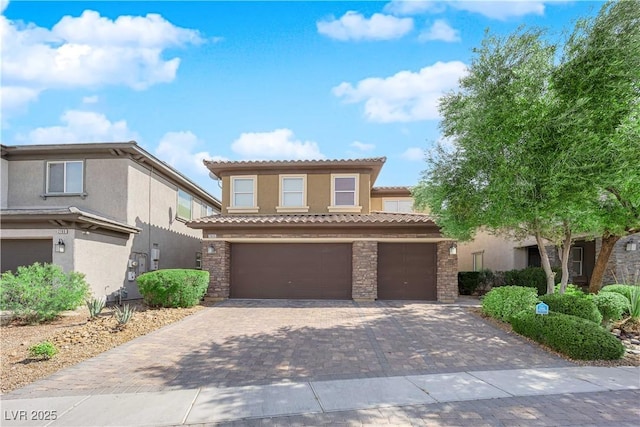 2033 Old Field Ave, North Las Vegas, NV 89081 - mediterranean / spanish-style house featuring stucco siding, decorative driveway, a tiled roof, stone siding, and a garage