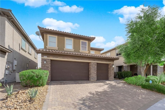 2033 Old Field Ave, North Las Vegas, NV 89081 - mediterranean / spanish-style house with stucco siding, an attached garage, stone siding, and a tiled roof