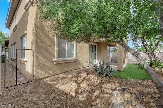 2033 Old Field Ave, North Las Vegas, NV 89081 - view of home's exterior featuring stucco siding, a fenced backyard, and a patio area