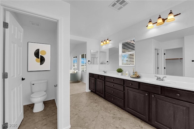 2033 Old Field Ave, North Las Vegas, NV 89081 - full bathroom featuring double vanity, toilet, baseboards, and tile patterned floors