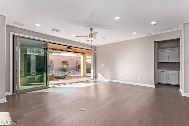 unfurnished room with dark hardwood / wood-style floors and ceiling fan