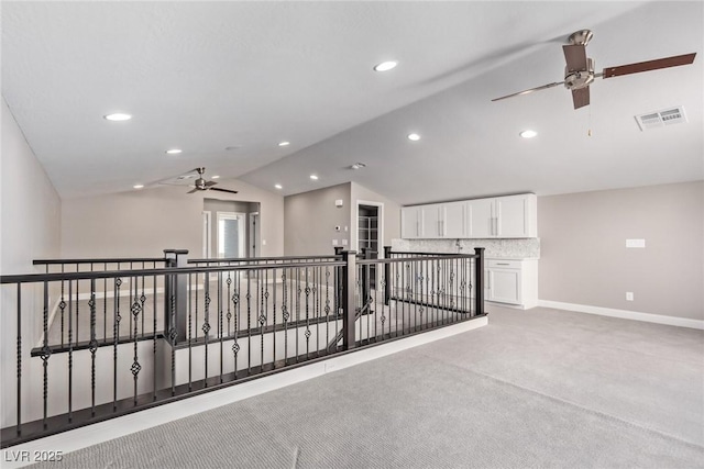 interior space featuring lofted ceiling and light colored carpet