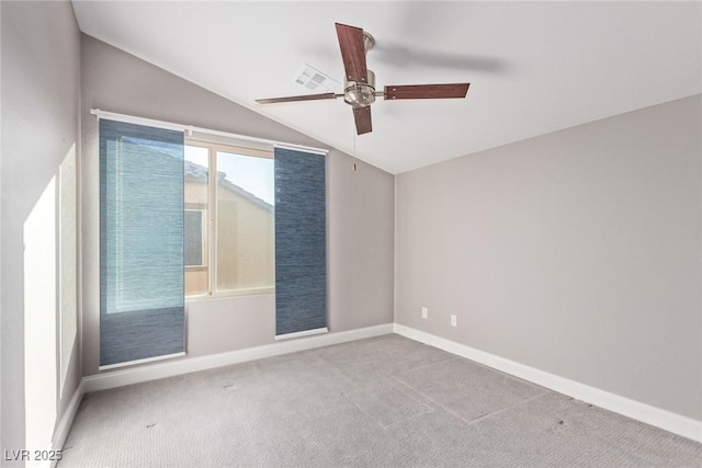 spare room with ceiling fan, light colored carpet, and lofted ceiling