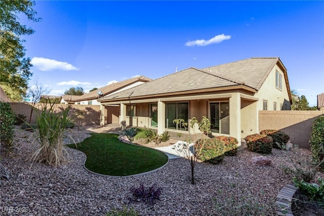 back of house with a yard and a patio area