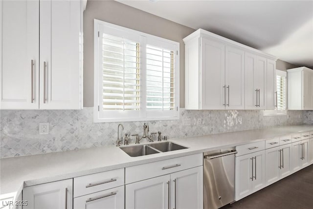 kitchen featuring white cabinetry, sink, and backsplash